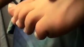 Hunk Showing His Feet While Tugging On His Hard Cock