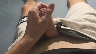 Athletic guy in white shorts jerks off his cock and cums