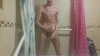 Hot very skinny guy with flat butt strokes his wet cock and pisses