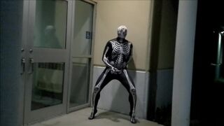 nighttime skeleton jerking off in front of outside doors