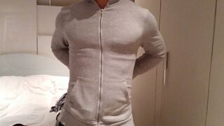 stripping and flexing through my hoodie, tanktop, briefs flexing my muscles