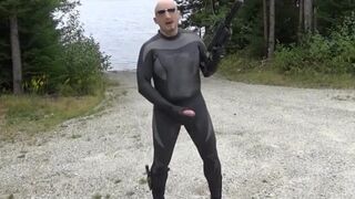 wetsuited silicone masked man on patrol near lake