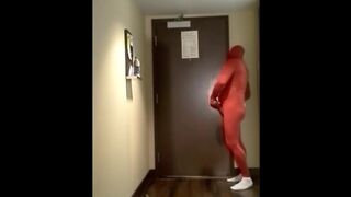 red morphsuit jerking off at hotel room door