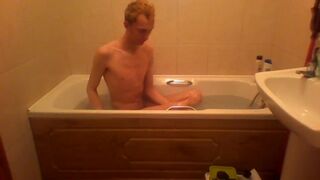 Blonde teen takes a warm bath in the bathtub