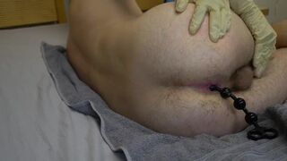 Teen works his tight ass with anal beads