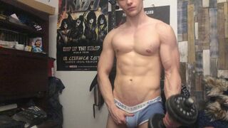 Chris Wild doing biceps curls and masturbates his big cock