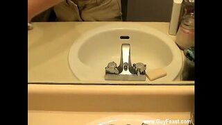 Male models William is trying to neat makeup off the bathroom mirror