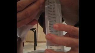 Anal enema with a big syringe.