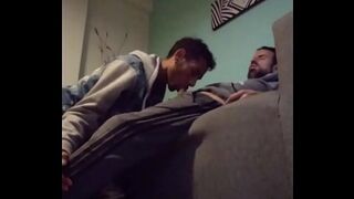 Male enjoys a delicious blowjob while relaxing on the couch.