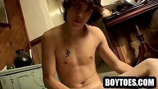 Horny hunk tugging his cock and showing off his feet