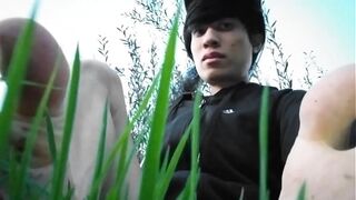 Jon Arteen in short shorts walks on grass barefoot, shows his boy soles, smiles for you