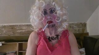 CD Sissy Sarah Millward knows her ID, as indicated by what's written on her face and chest - 'fag slut' - as she smokes, wanks her clit, and stuffs a dildo up her nasty lady hole