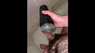 Young hairy daddy plays with flashlight in shower