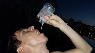 Daddy's son jerks off his meat on the riverbank and eats his sperm right after he cums in a glass