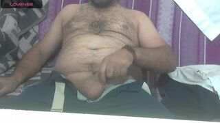 masculine turk bear plays with a cock at home because of boredom