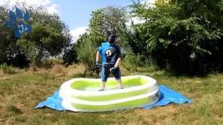 Cyclist pup in pool - cooling down and pawing off